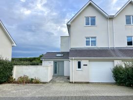 A house with a garage and entryway at 2 Lon Y Dryw in Trearddur Bay