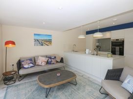 A living room with a sofa and coffee table at 2 Lon Y Dryw in Trearddur Bay