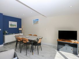 A dining room with a table and chairs at 2 Lon Y Dryw in Trearddur Bay