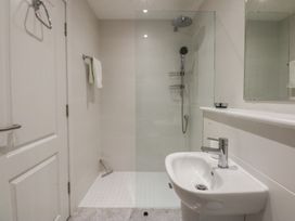 A bathroom with a shower and wash basin at 2 Lon Y Dryw in Trearddur Bay