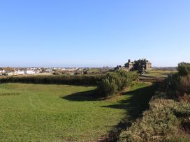 A landscape view with a house and grass at 2 Lon Y Dryw in Trearddur Bay