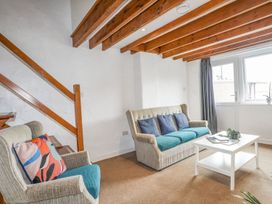 A living room with seating and coffee table at Cilan - 2 Ty'n Don in Llanengan near Abersoch