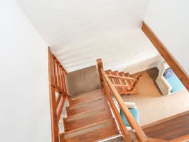 A staircase leading down to a living area at Cilan - 2 Ty'n Don Llanengan near Abersoch