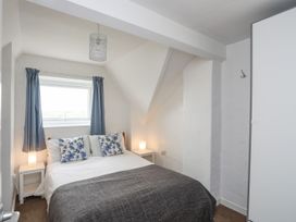 A bedroom with a bed and window at Cilan - 2 Ty'n Don in Llanegan near Abersoch