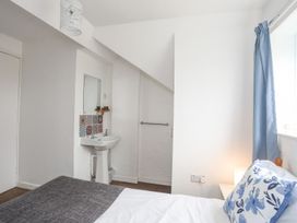 A bedroom with a hand basin and window at Cilan - 2 Ty'n Don Llanengan near Abersoch