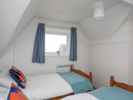 A bedroom with two single beds and a window at Cilan - 2 Ty'n Don, Llanengan near Abersoch