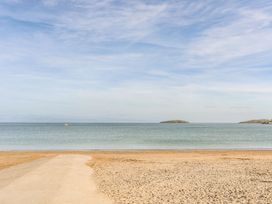A beach scene with sand and water at Cilan - 2 Ty'n Don Llanengan near Abersoch
