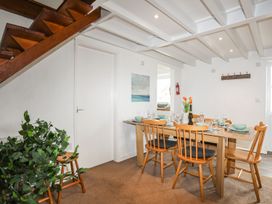 A dining room with a table and chairs at Rhiw - 1 Ty'n Don Abersoch