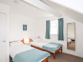 A bedroom with two beds and a window at Rhiw - 1 Ty'n Don in Abersoch