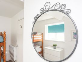 A bedroom with bunk beds and a chest of drawers at Rhiw - 1 Ty'n Don in Abersoch