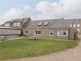 An outdoor area showing a house with solar panels at Rhiw - 1 Ty'n Don Abersoch