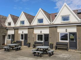 A building with multiple units and outdoor seating at Rhiw - 1 Ty'n Don Abersoch