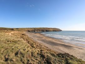 A beach with cliffs and ocean at Rhiw - 1 Ty'n Don in Abersoch