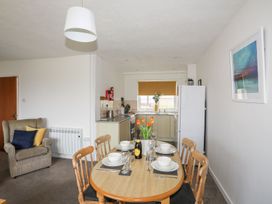A dining area with a table and chairs at Oer - 8 Ty'n Don, Llanengan near Abersoch