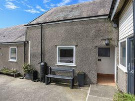 An exterior view of a property entrance with a bench at Ysgo - 6 Ty'n Don Abersoch