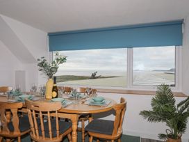 A dining room with a table set for meals at Ysgo - 6 Ty'n Don Abersoch