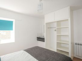 A bedroom with a bed and closet at Ysgo - 6 Ty'n Don Abersoch