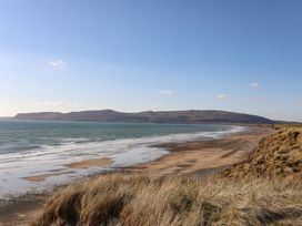 A beach with sand and water at Ysgo - 6 Ty'n Don Abersoch