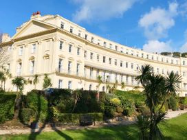 A building with balconies and gardens at Meadfoot Bay Apartment at Hesketh Crescent Torquay