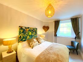 A bedroom with a bed and bedside table at Meadfoot Bay Apartment at Hesketh Crescent, Torquay