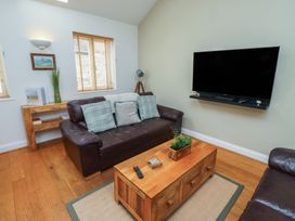 A living room with a sofa and coffee table at Hideaway Cottage No 1 Seahouses