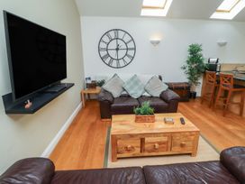 A living room with a television and sofa at Hideaway Cottage No 1 in Seahouses