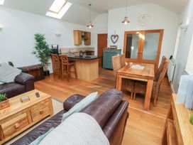 A living area with a sofa and dining space at Hideaway Cottage No 1, Seahouses