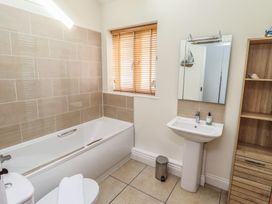 A bathroom with a bathtub and sink at Hideaway Cottage No 1 Seahouses