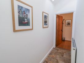 A hallway with photographs on the wall at Hideaway Cottage No 1 Seahouses