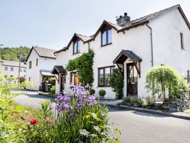 A house with flowers in front at Dolly Blue Backbarrow near Newby Bridge