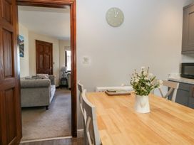 A kitchen with a dining table and chairs at Dolly Blue in Backbarrow near Newby Bridge