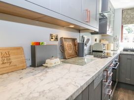 A kitchen with countertop appliances and utensils at Dolly Blue Backbarrow near Newby Bridge
