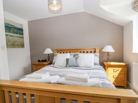 A bedroom with a bed and bedside tables at Dolly Blue in Backbarrow near Newby Bridge