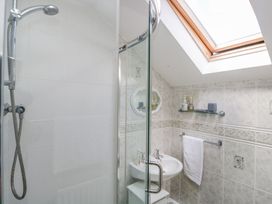 A bathroom featuring a shower and sink at Dolly Blue Backbarrow near Newby Bridge
