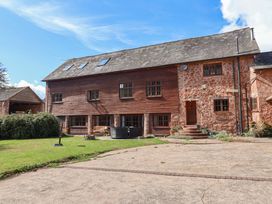 A house with multiple windows and a door at Millbarn in Crowcombe