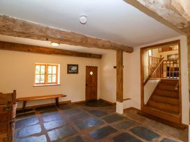 A hallway with a bench and a staircase at Millbarn in Crowcombe