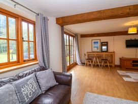 A living room with a sofa and dining table at Millbarn in Crowcombe
