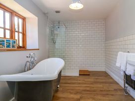 A bathroom featuring a bathtub and shower at Millbarn in Crowcombe