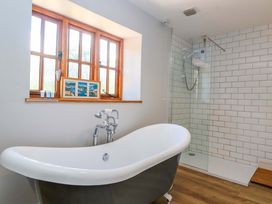 A bathroom with a bathtub and shower at Millbarn in Crowcombe