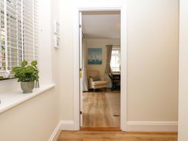 A hallway with a plant and a view of a living room at 2 Sheplegh Court Blackawton near Dartmouth