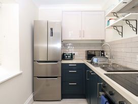 A kitchen with appliances and storage at 2 Sheplegh Court in Blackawton near Dartmouth