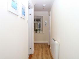 A hallway with a window and pictures on the wall at 2 Sheplegh Court Blackawton near Dartmouth