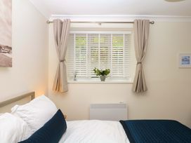 A bedroom with a bed and window at 2 Sheplegh Court Blackawton near Dartmouth