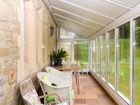 A conservatory with chairs and a table at 2 Sheplegh Court in Blackawton near Dartmouth