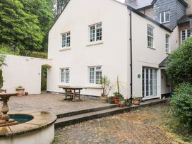 An outdoor area with a table and plants at 2 Sheplegh Court Blackawton near Dartmouth
