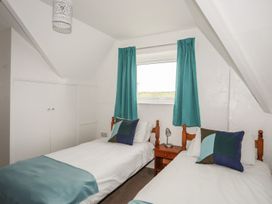 A bedroom with two beds and a window at Fadrun - 3 Ty'n Don