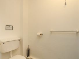 A bathroom with a toilet and toilet paper holder at Fadrun - 3 Ty'n Don