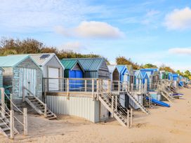 Beach huts with stairs and sand at Penrhyn - 4 Ty'n Don