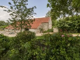 A building surrounded by trees and plants at The End in Langport