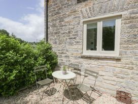 An outdoor seating area with a table and chairs at The End in Langport